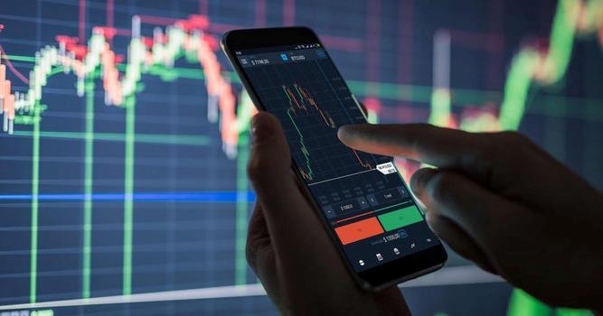 Close-up of a hand trading cryptocurrency and shares on a mobile online trading app